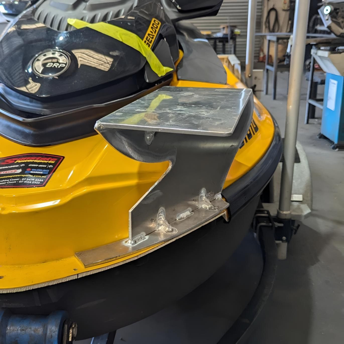 A Yellow and Black Jet Ski is Parked in a Garage — Turnweld Engineering in Coolum Beach, QLD