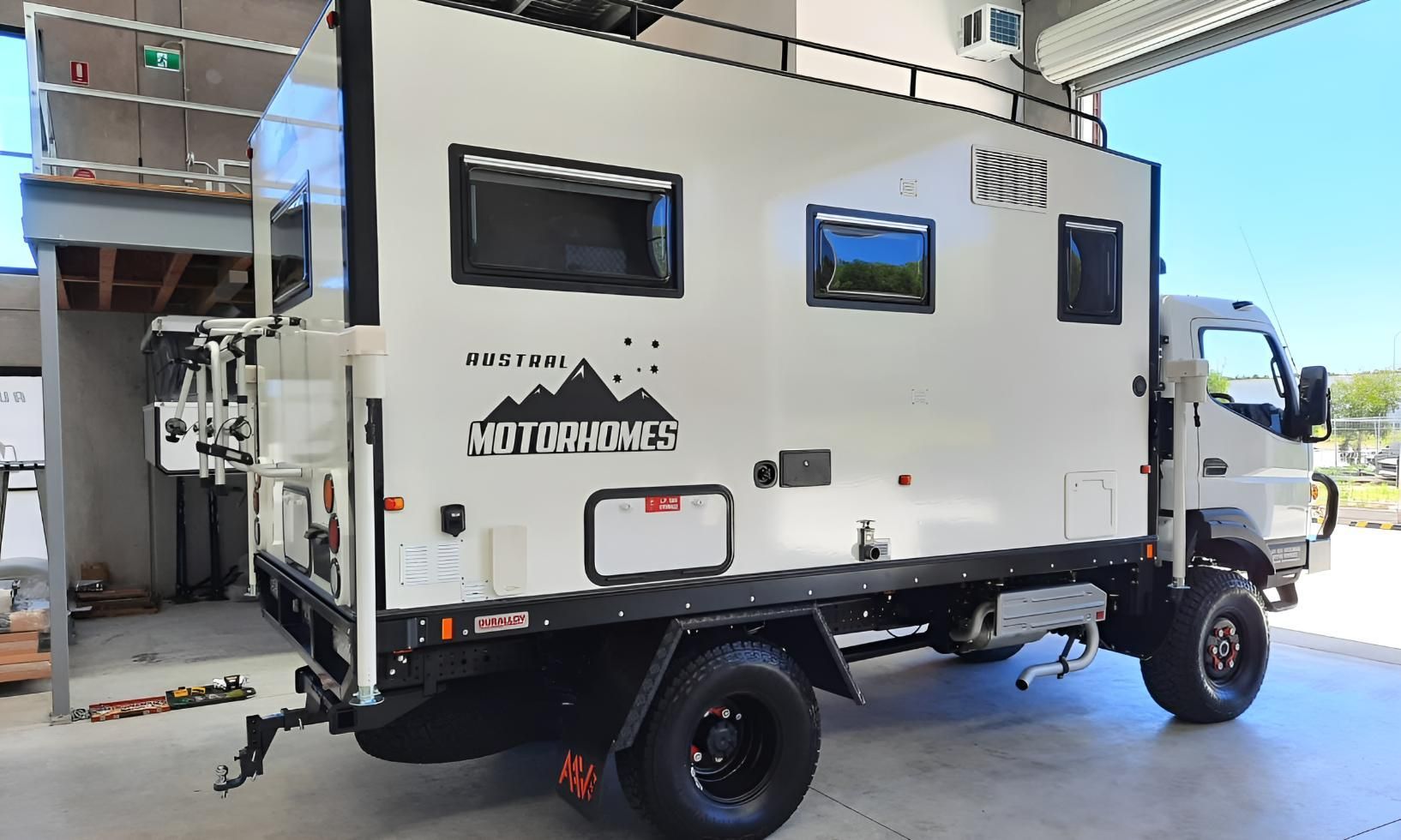 A White Truck With a Trailer Attached to It is Parked in a Garage — Turnweld Engineering in Coolum Beach, QLD