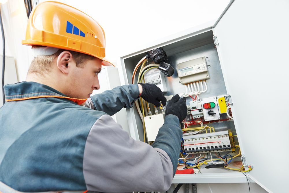 An Electrician Working on An Electrical Panel — Paul Wiedman Electrical in Oakey, QLD