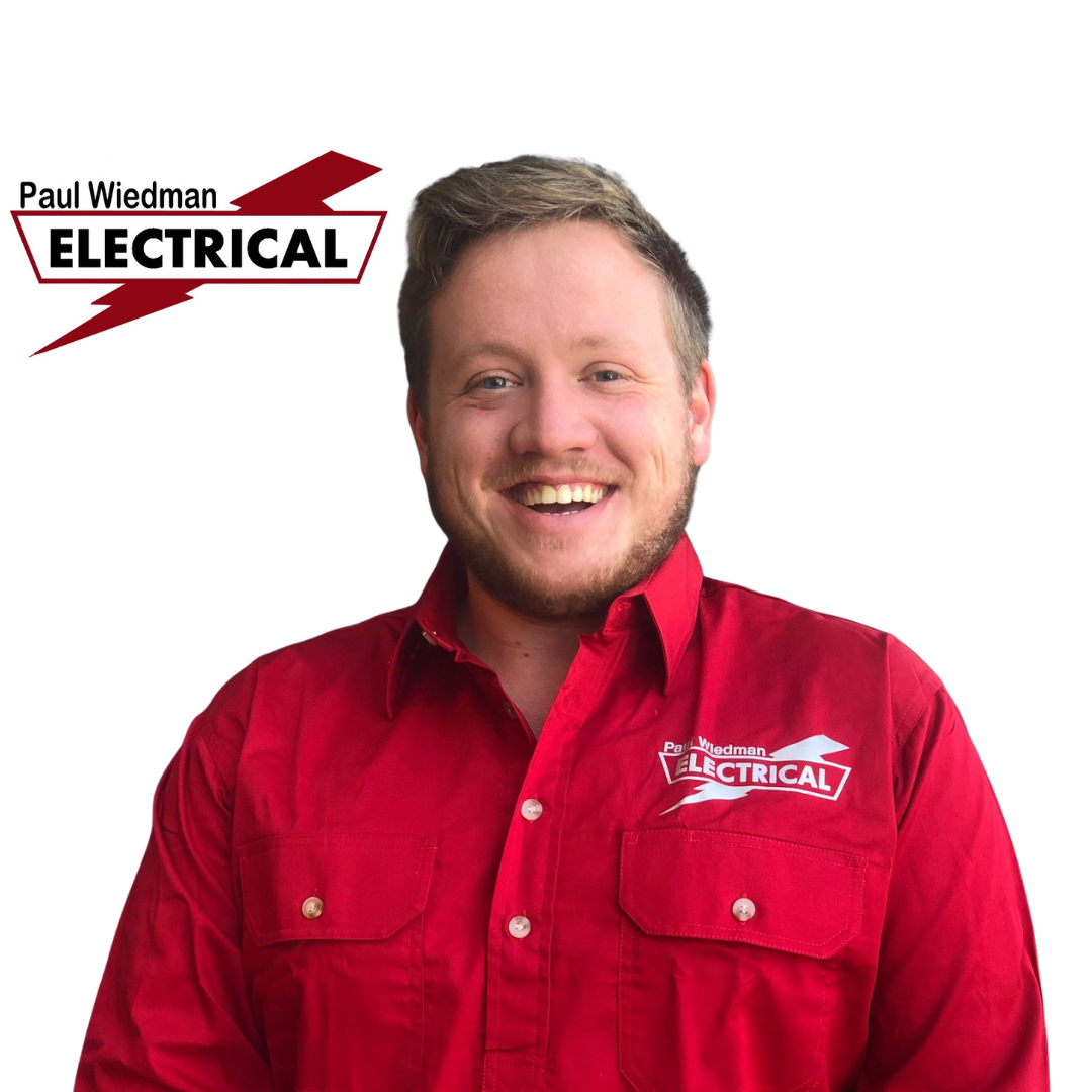 Man wearing red work shirt smiling, logo 