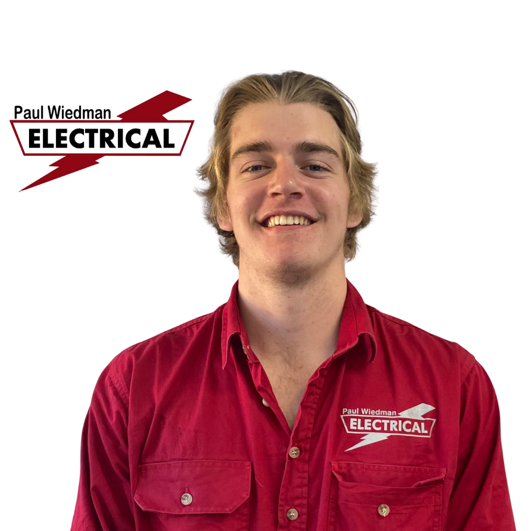 Man in red shirt smiling, with 