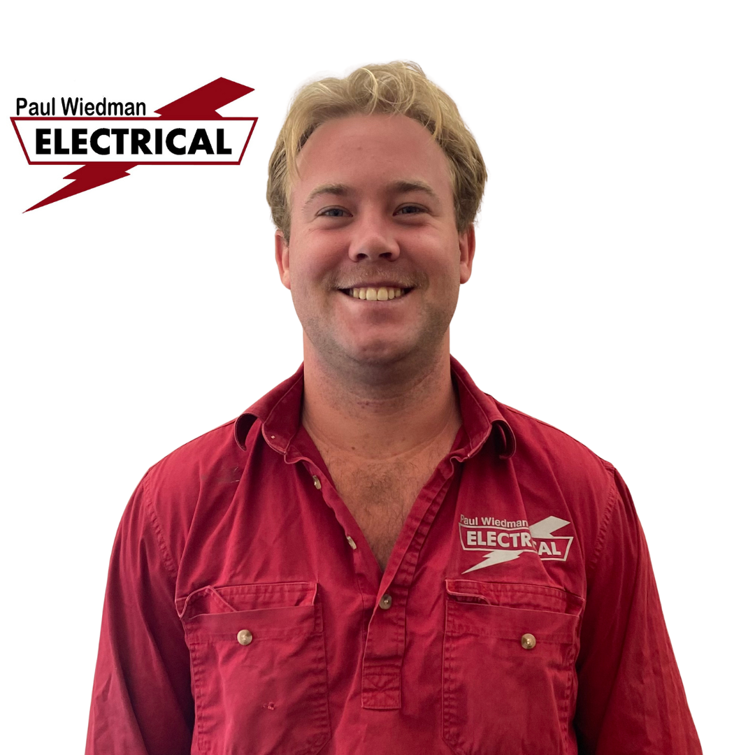 Man in red shirt smiling, with 