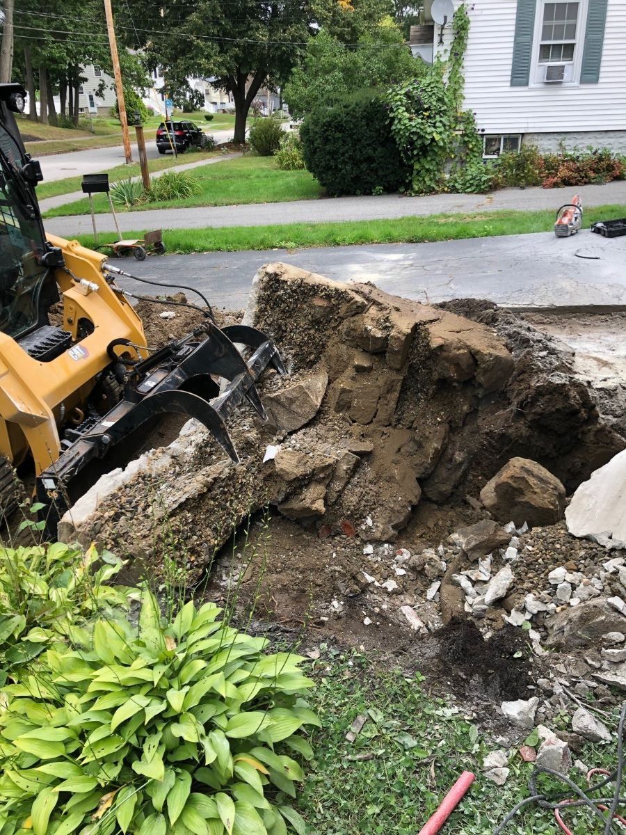 Using the Excavator to remove concrete on a residential property