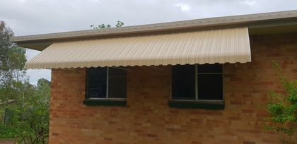 Aluminium Awning Over Brick House — Shutters in Bundaberg, QLD