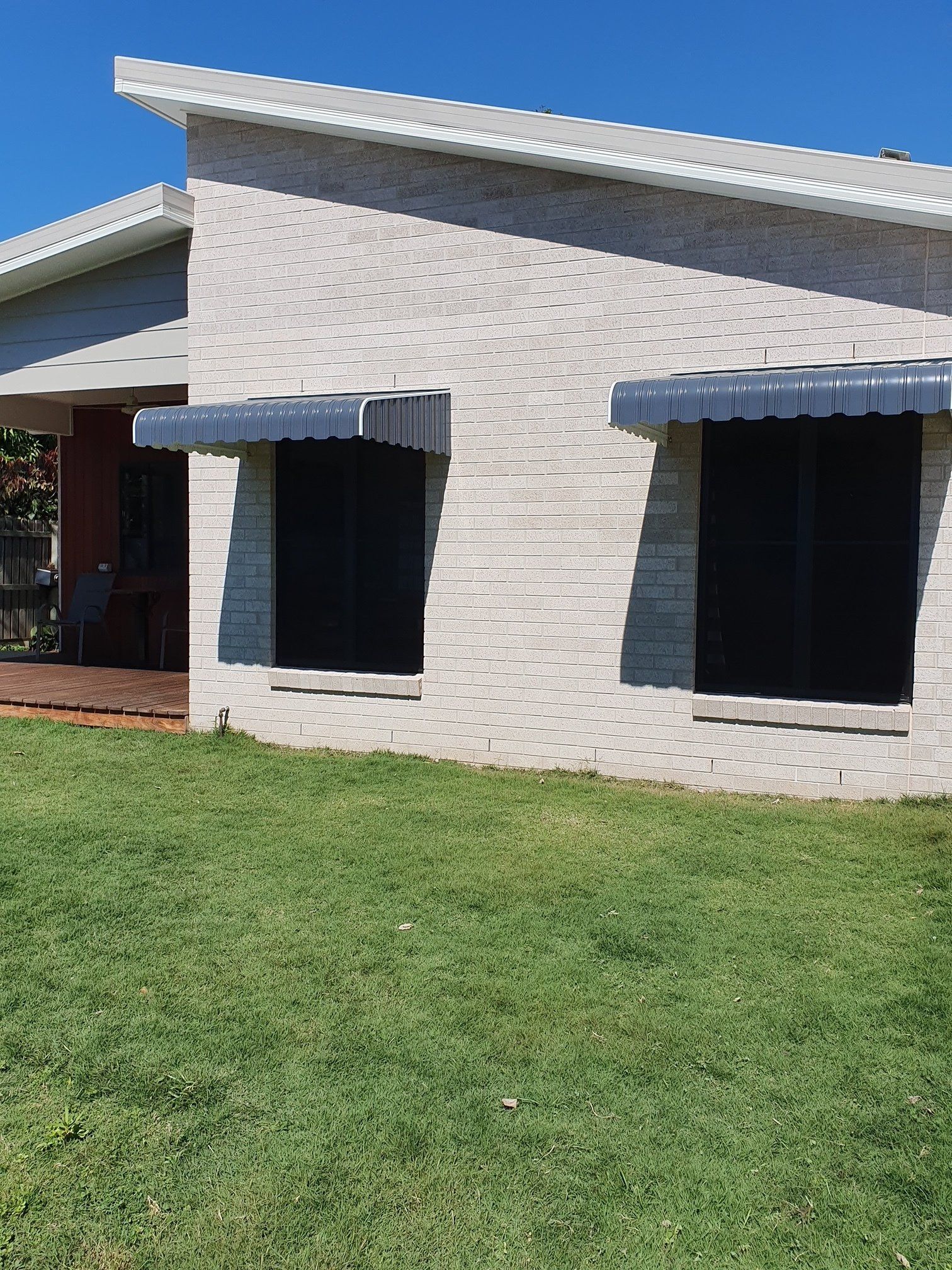 Blue Two Awning With Windows Outside The Home — Blinds Awning installation in Bundaberg QLD