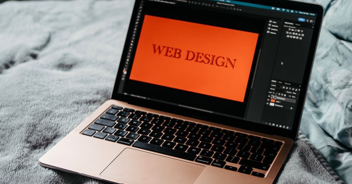A laptop computer is open to a web design screen.