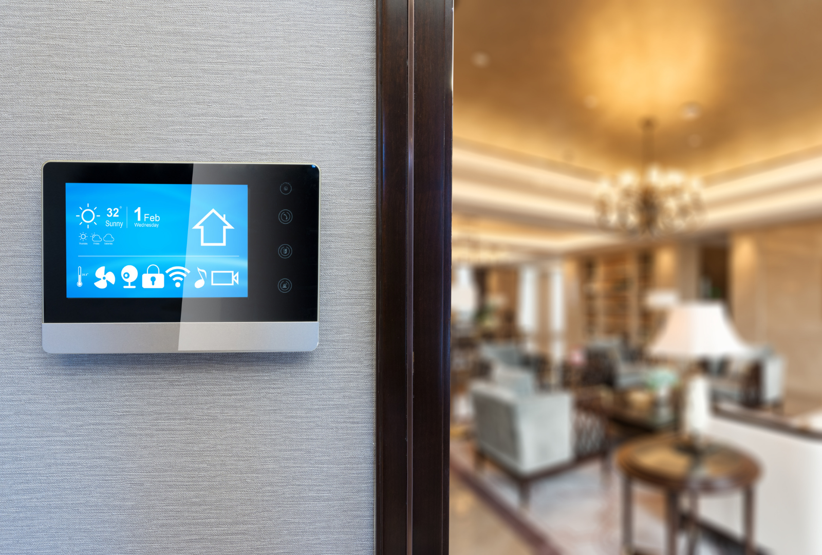 Smart home control panel on a wall, displaying settings, with a blurred interior living room in the background.