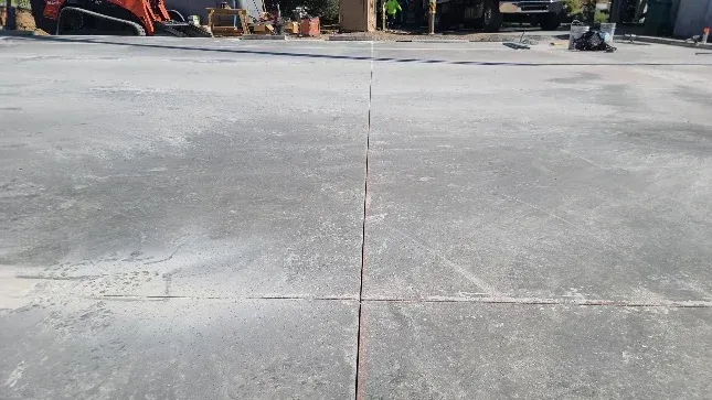A close up of a concrete floor with a few lines on it.