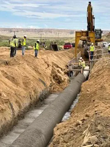 A group of construction workers are working on a flow fill
