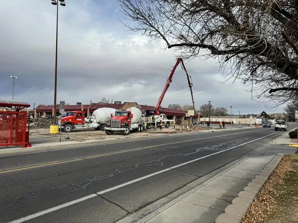 A concrete pump is being used on the side of the road