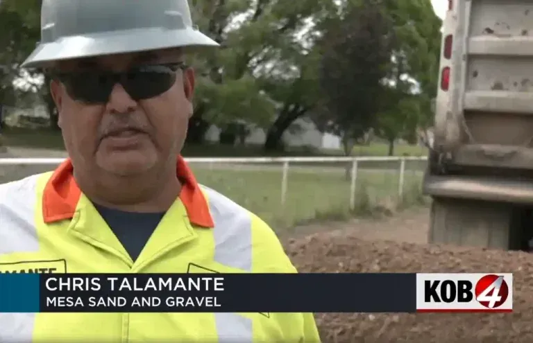 Chris Talamante is wearing a hard hat and sunglasses from Mesa Sand and Gravel