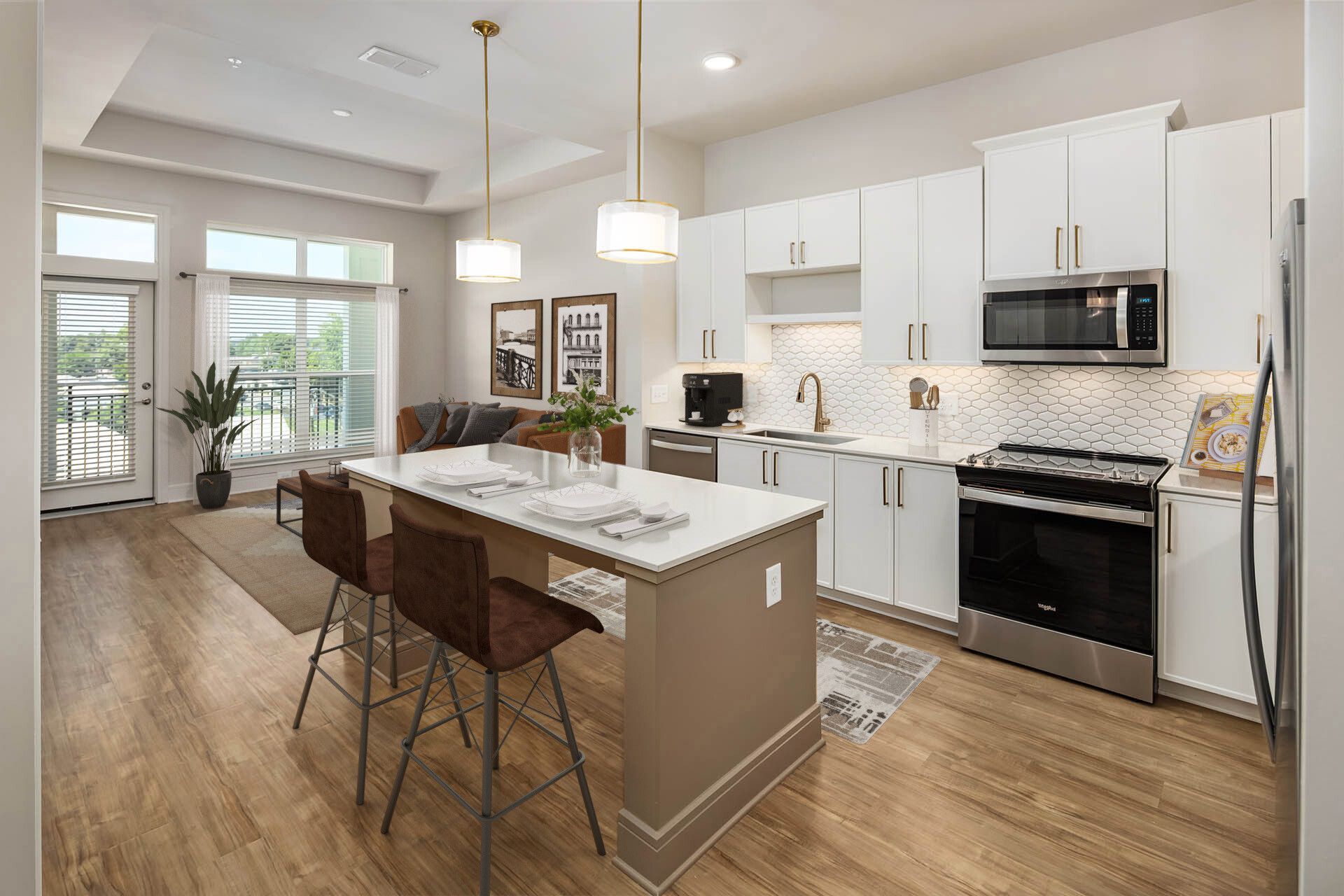 A kitchen with white cabinets and stainless steel appliances and a large island in the middle.