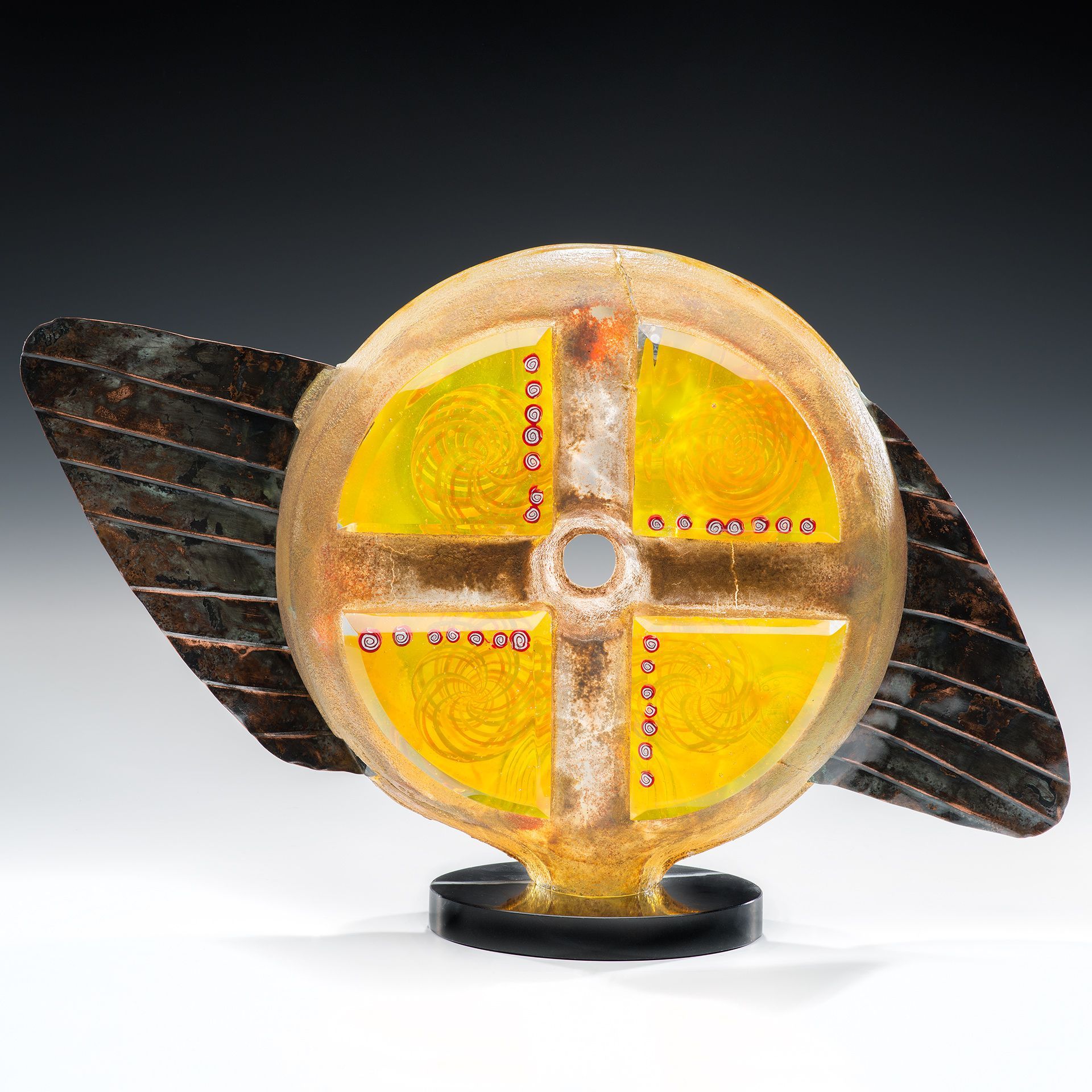 A sculpture of a wheel with a hole in the middle