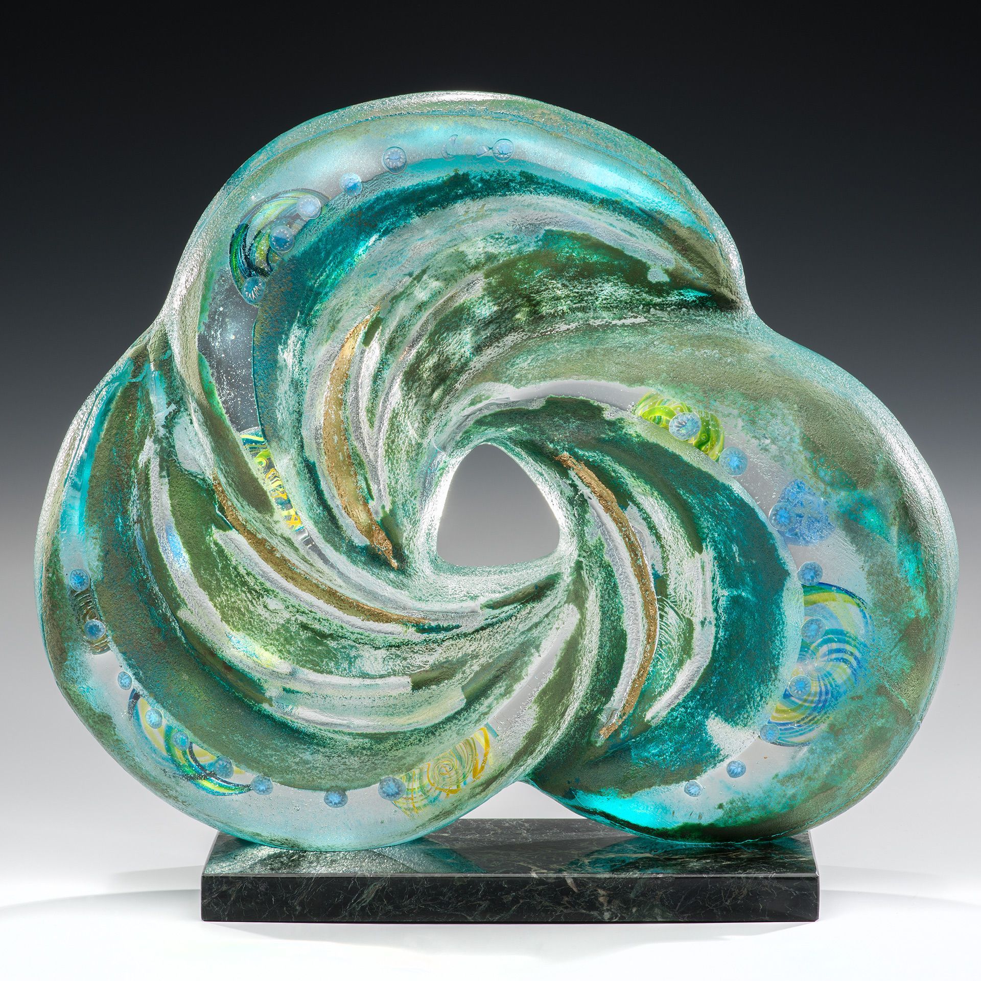 A blue and green sculpture with a hole in the middle