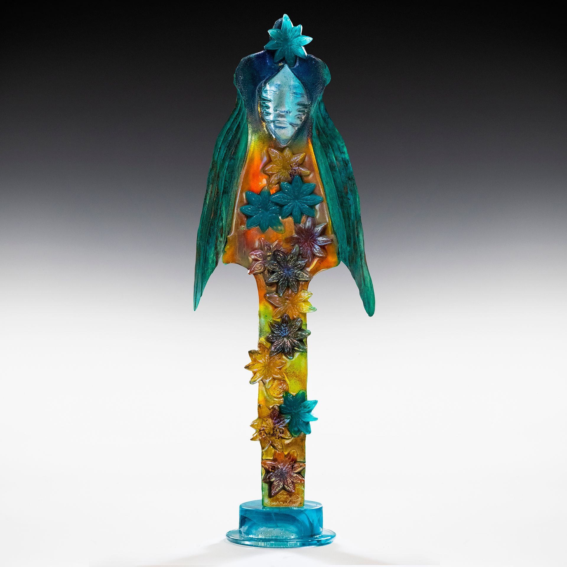 A statue of a bird with a face on it