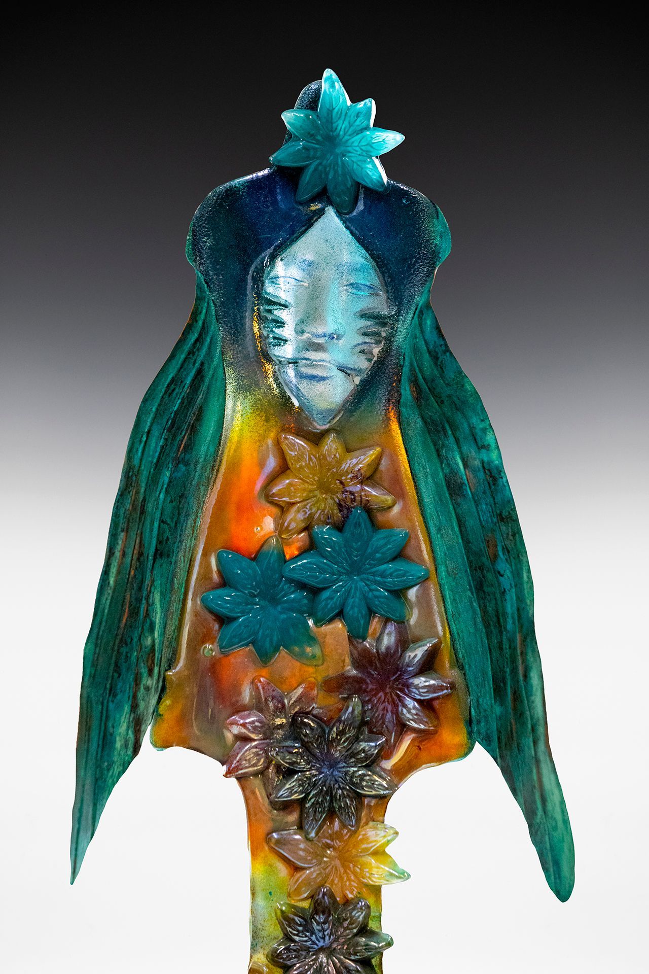 A statue of a woman with flowers and a star on her head