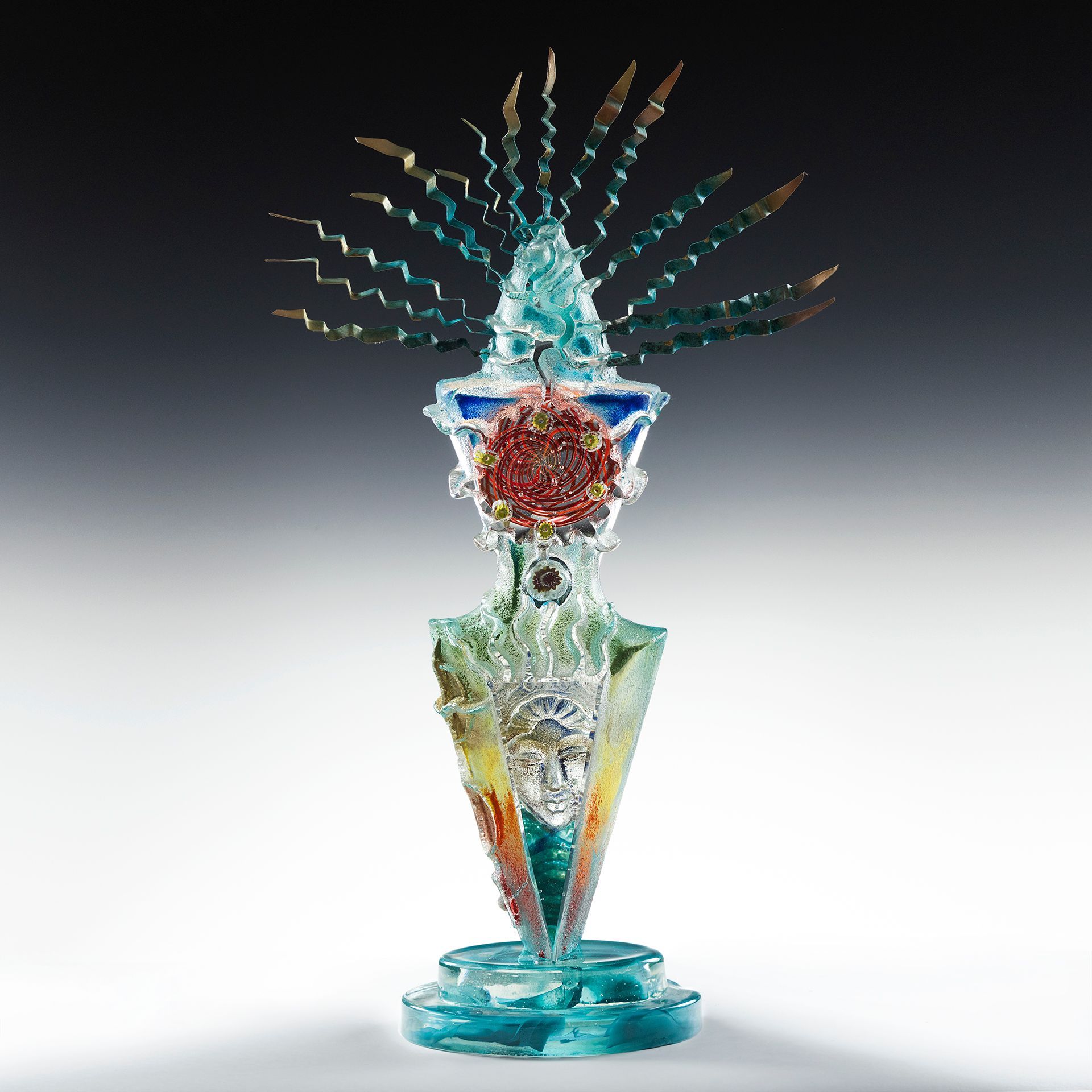 A colorful glass sculpture with a feathered hat on top