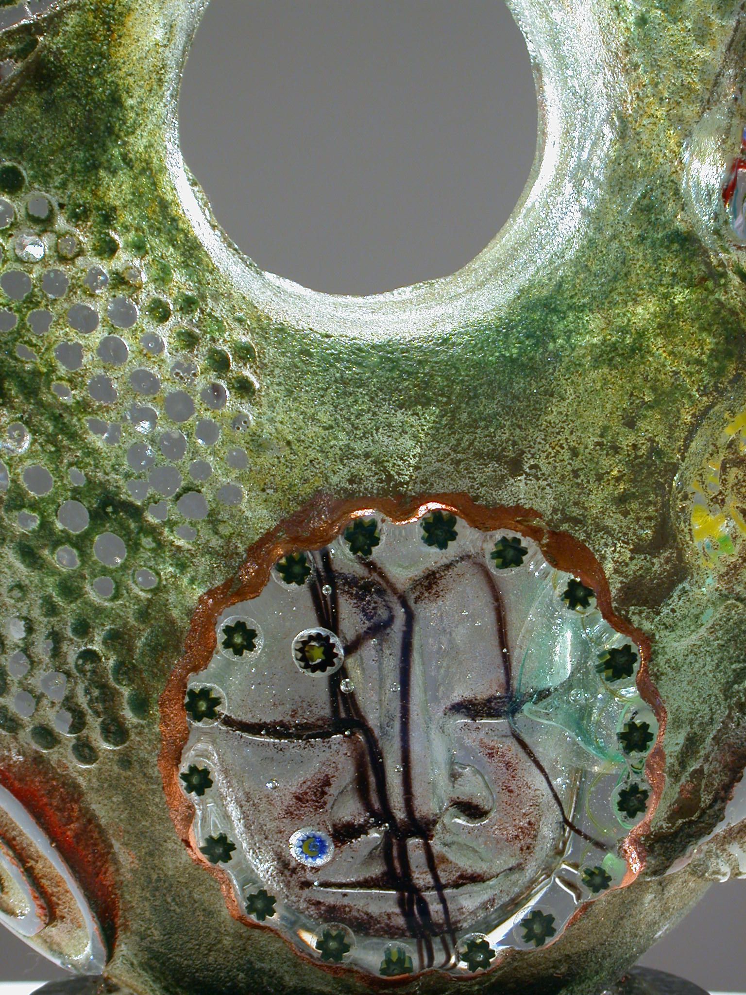 A close up of a ceramic sculpture with a hole in the middle.