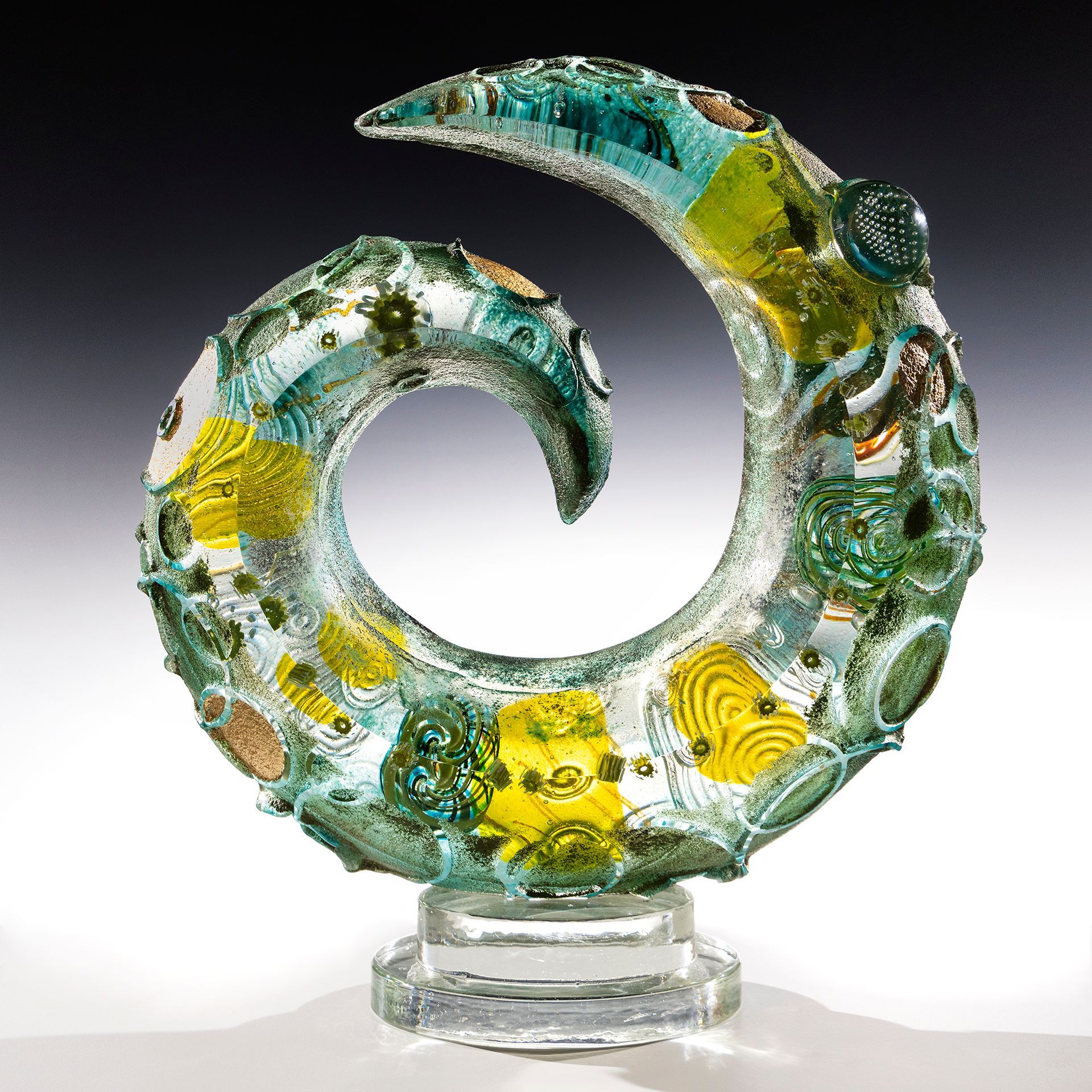A glass sculpture of a swirl on a clear base