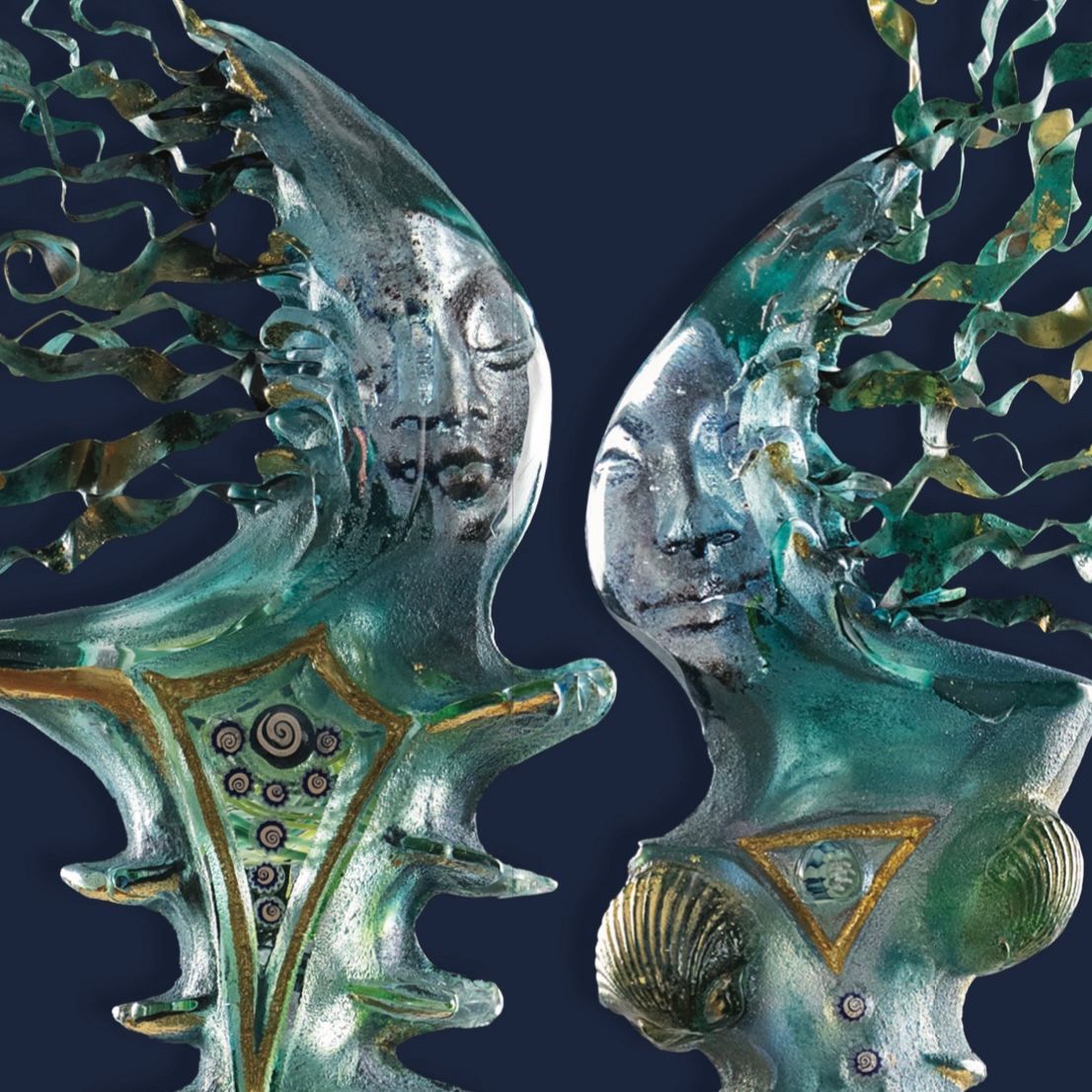 A statue of two faces with wings on a blue background