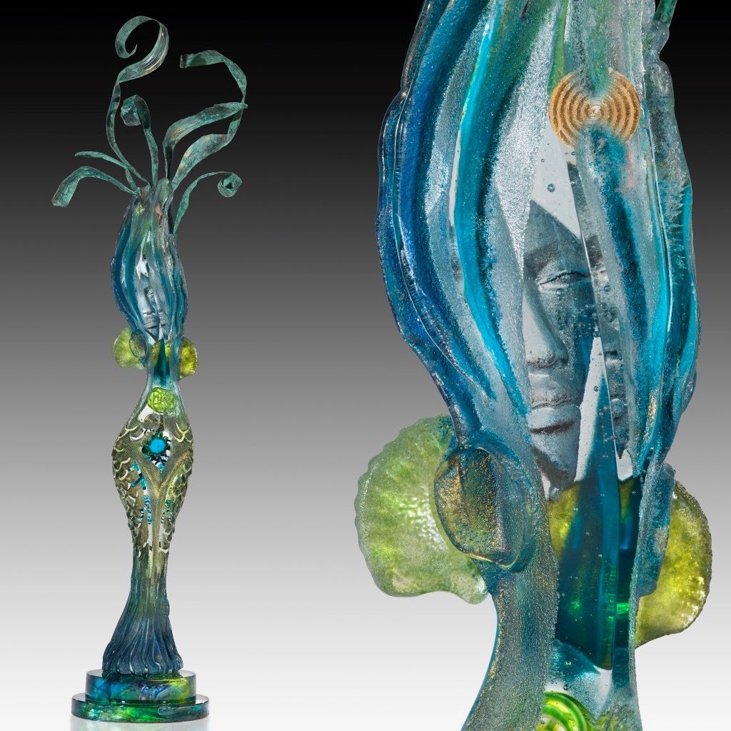A glass sculpture with a face on it