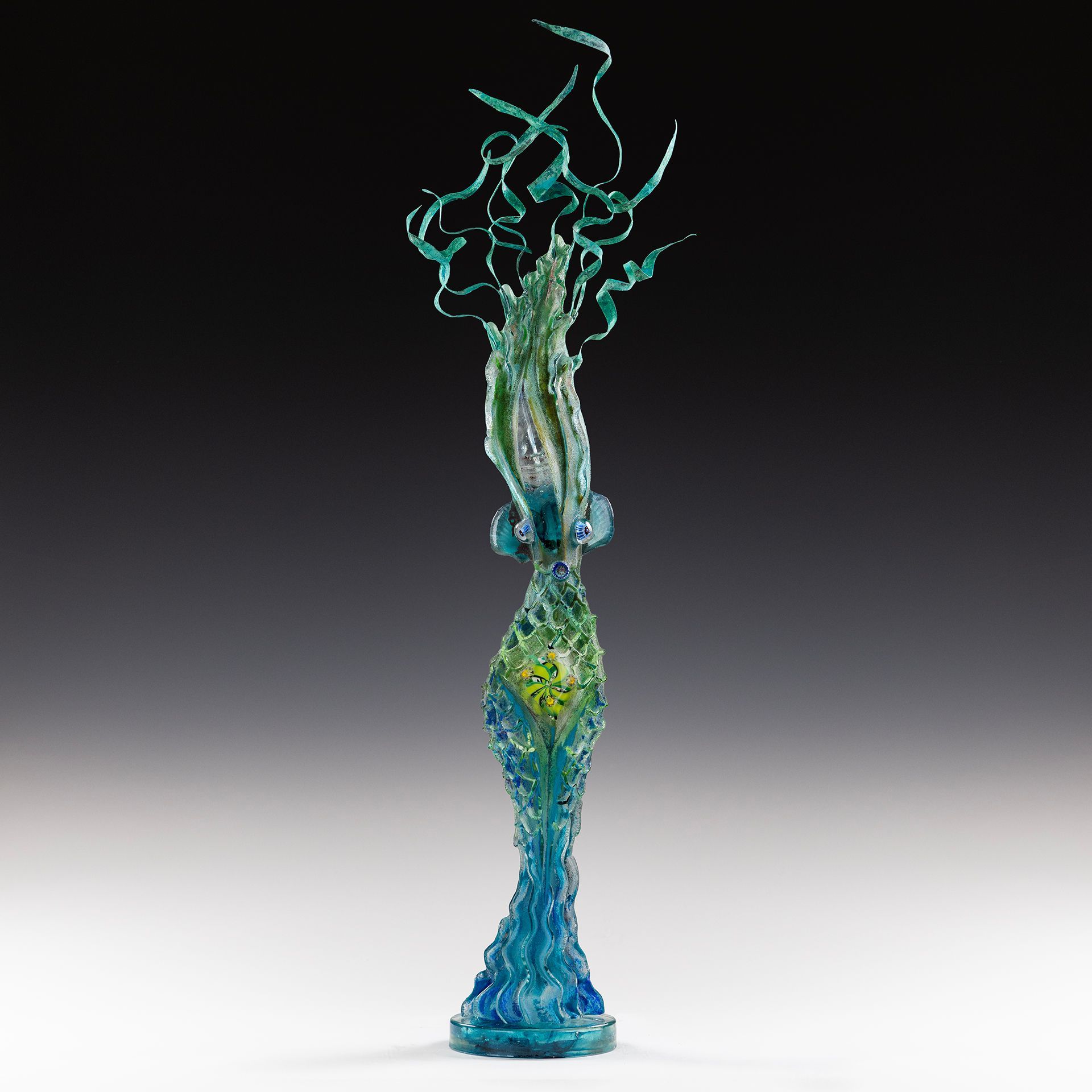 A statue of a woman with a blue base