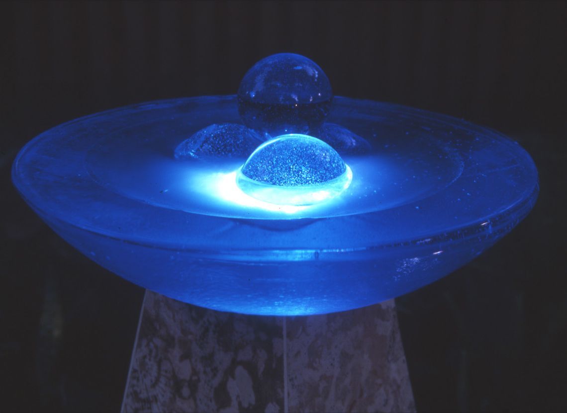 A bowl of water with blue lights on it