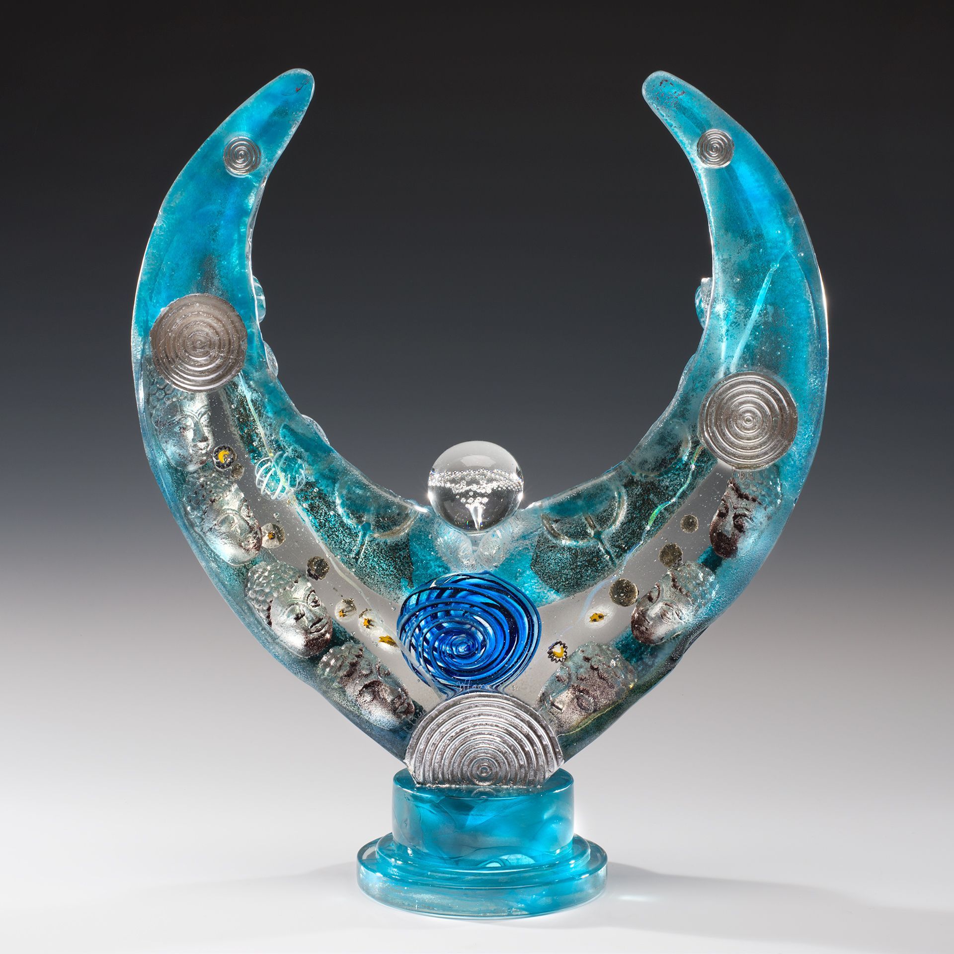 A blue and silver sculpture of a crescent moon