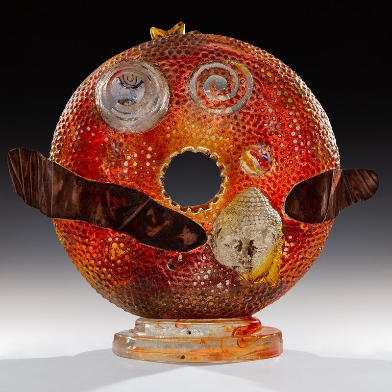 A sculpture of a face with a hole in the middle