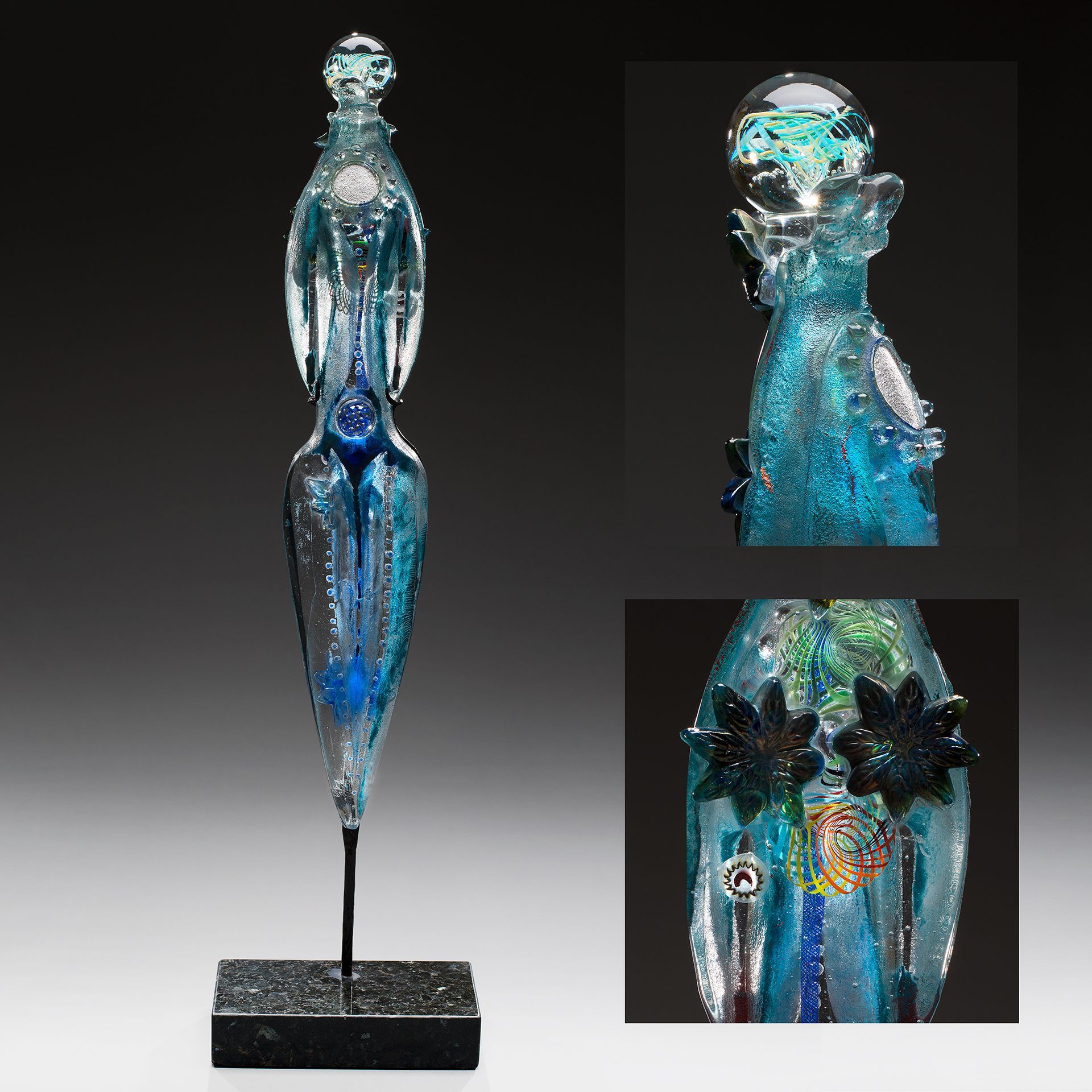 A blue glass sculpture of a woman is on a stand