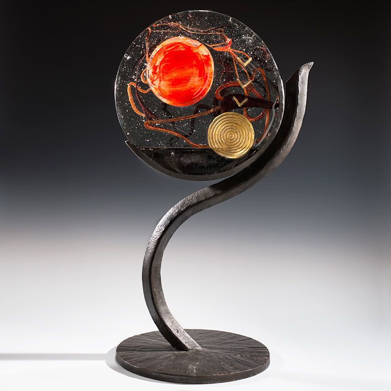 A sculpture of a globe on a metal stand