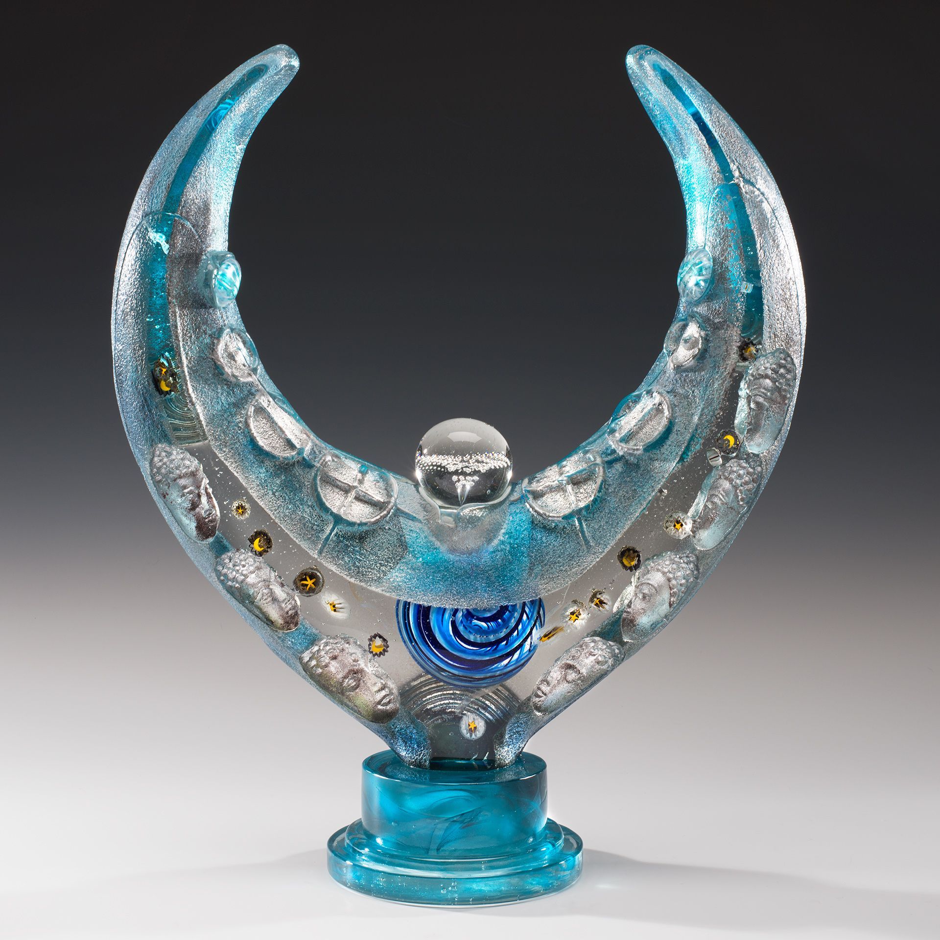 A blue and silver sculpture of a crescent moon
