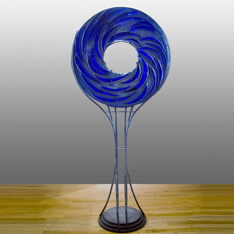 A blue sculpture is sitting on a wooden table