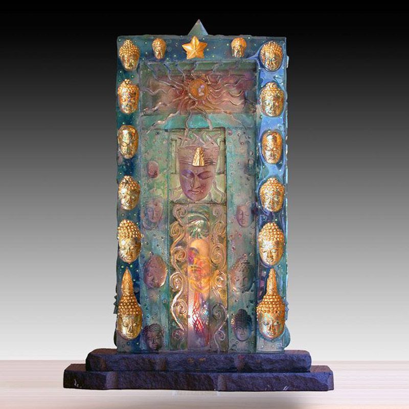 A statue with many faces and a star on top