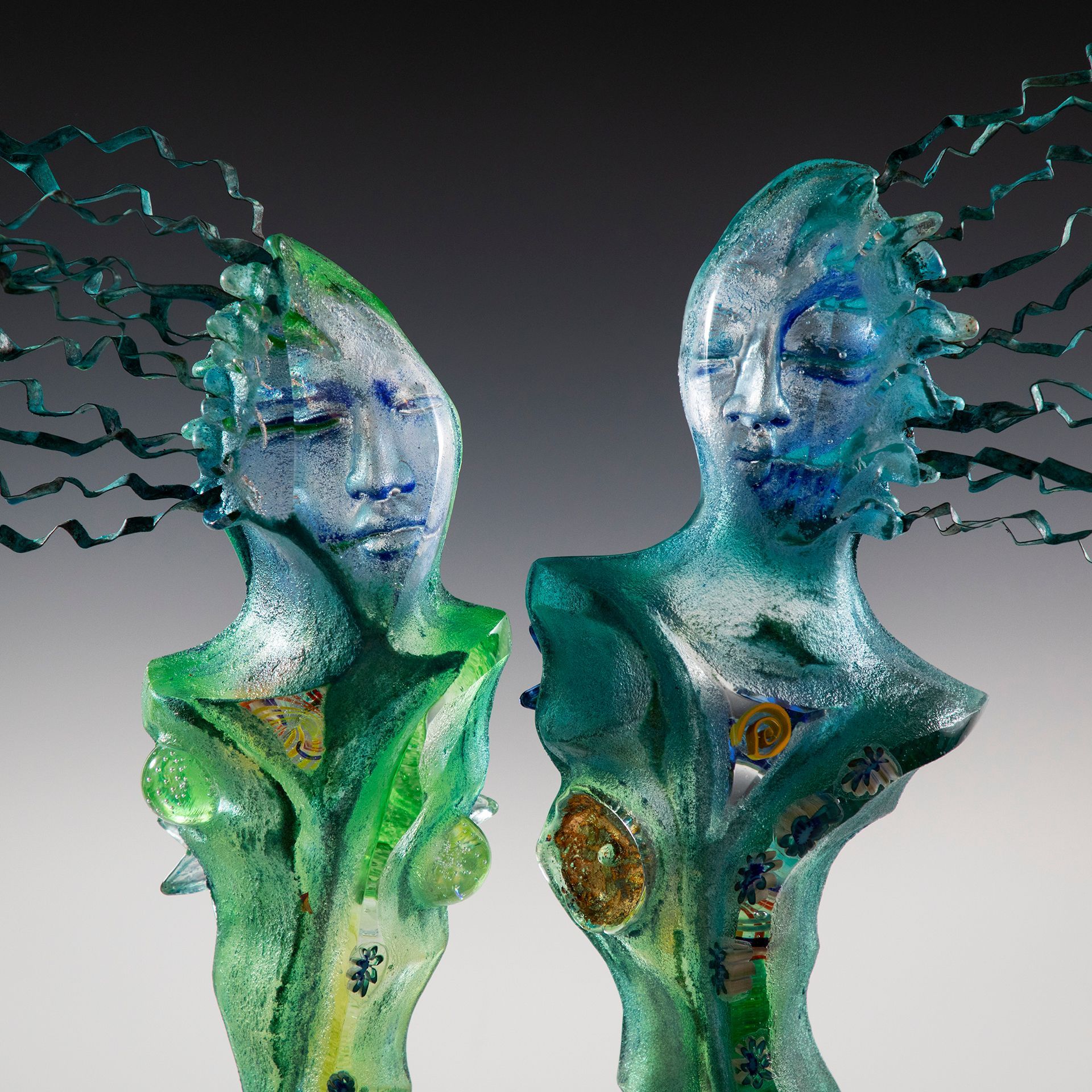 Two sculptures of a man and a woman are standing next to each other