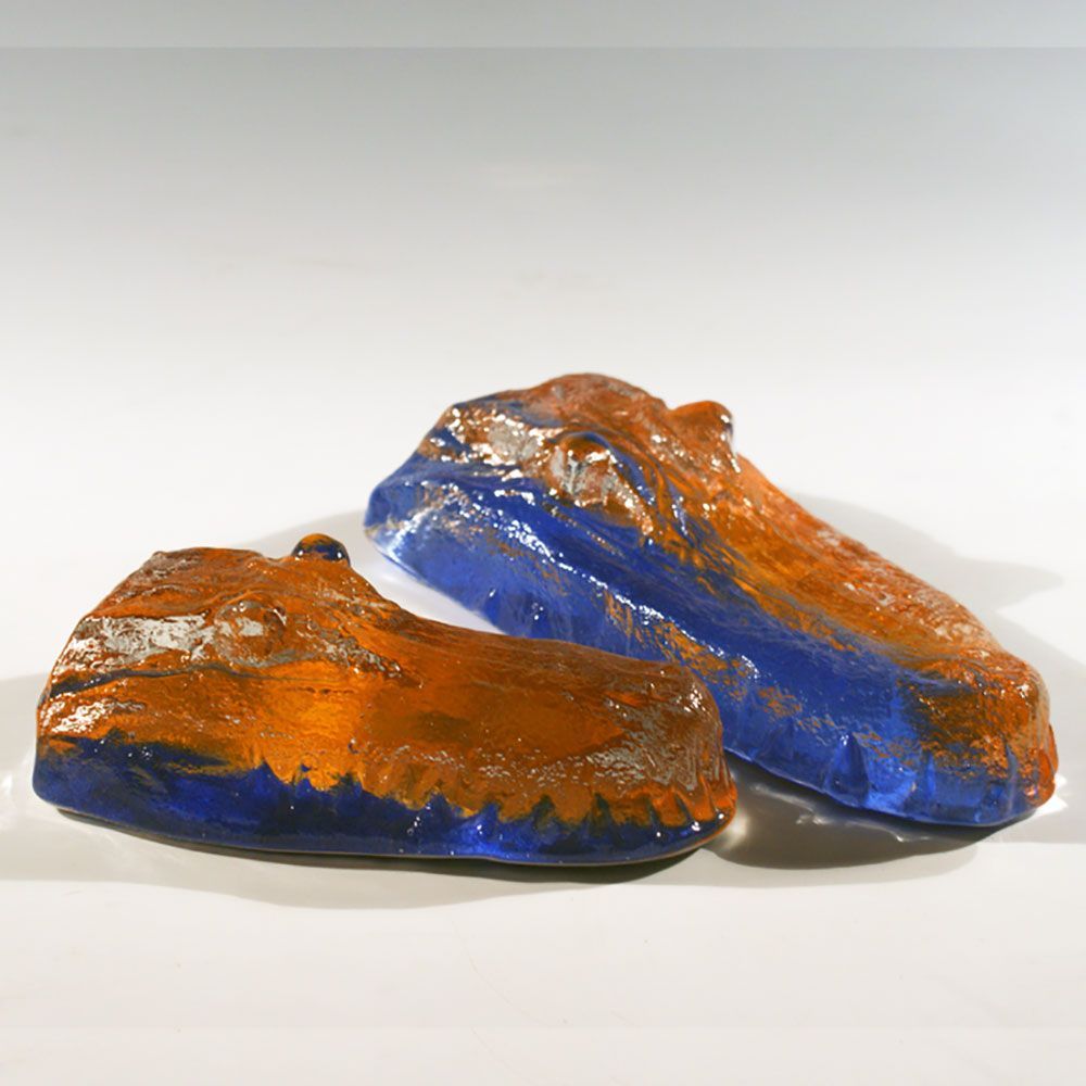 A pair of blue and orange rocks on a white surface
