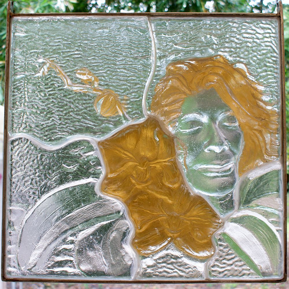 A stained glass window with a woman 's face on it