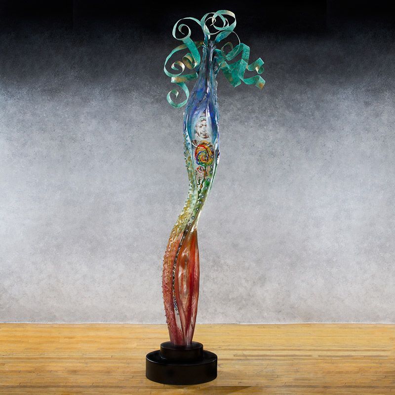 A colorful sculpture is sitting on a wooden table