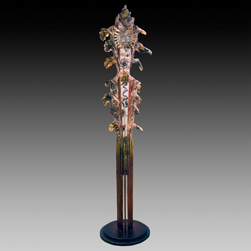 A statue that looks like a tree with leaves on it