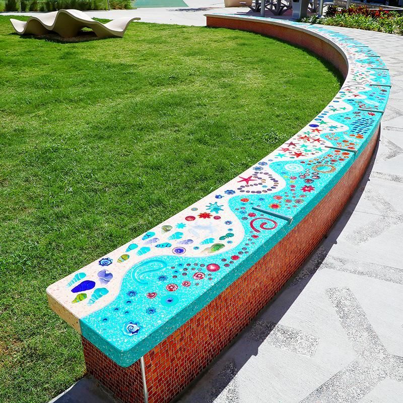 A bench with a colorful design on it in a park