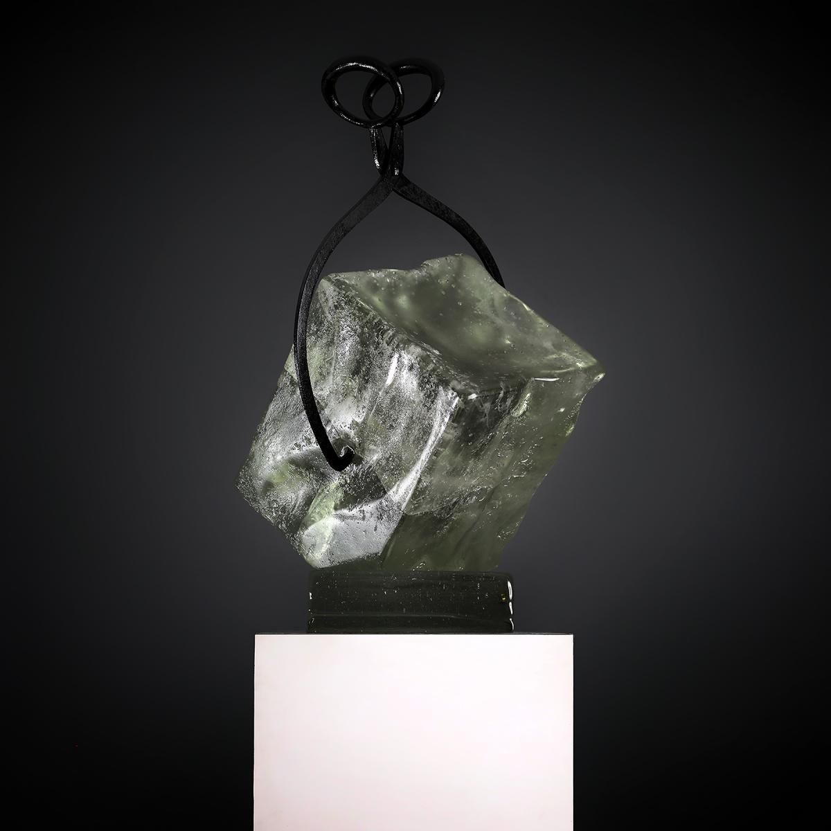 A sculpture of a pair of scissors holding a piece of ice