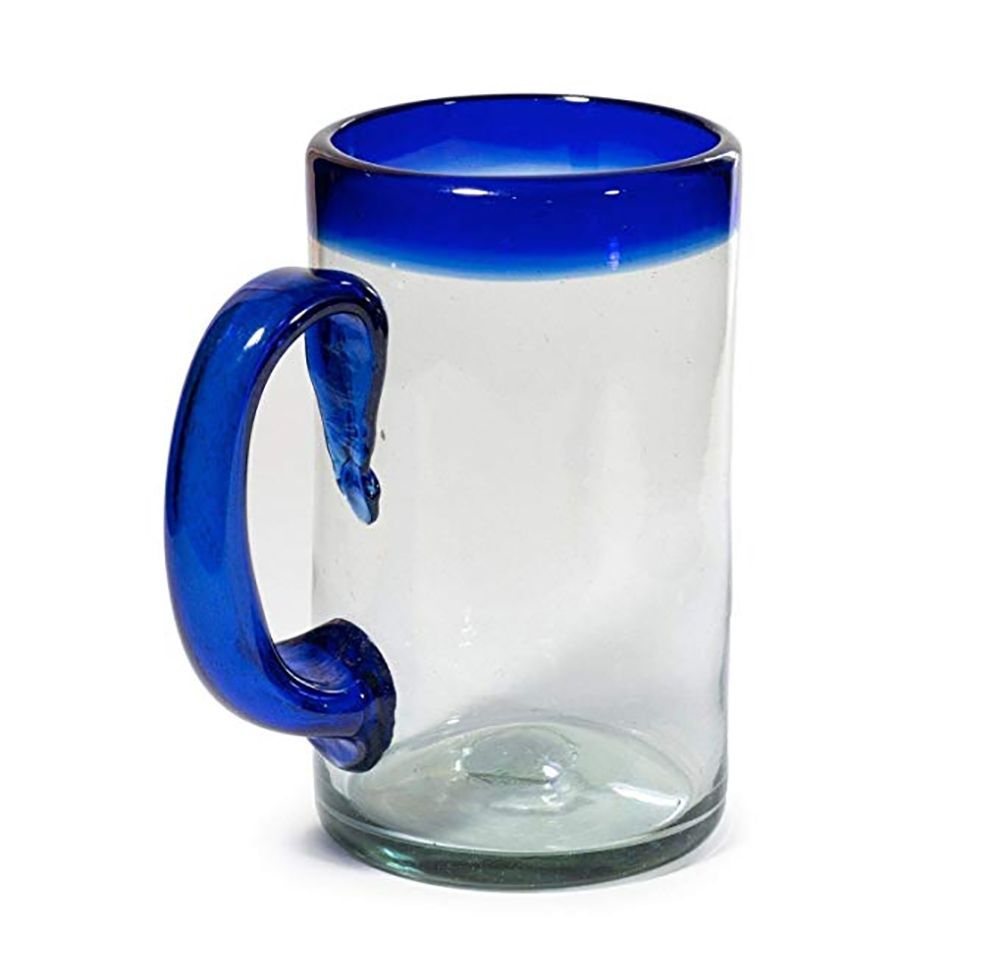 A clear glass mug with a blue handle on a white background