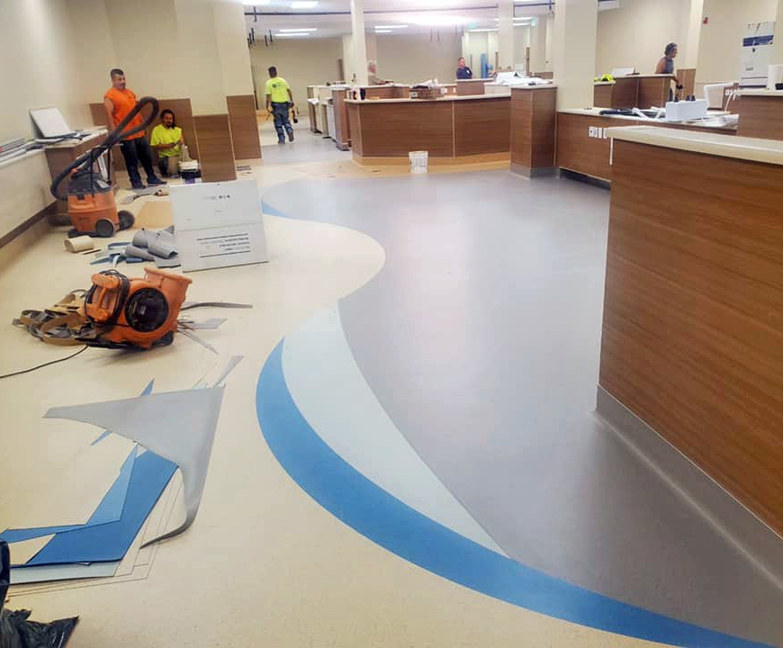 Detailed laminate flooring has been installed in this hospital wait room.
