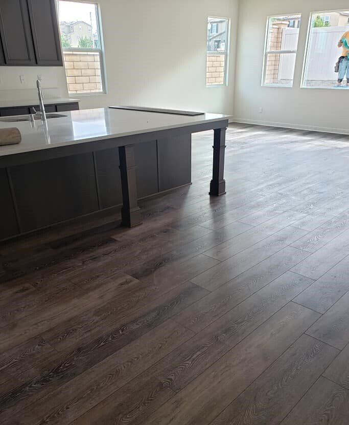 These uniform planks of hardwood flooring create a more modern look in this open concept kitchen.