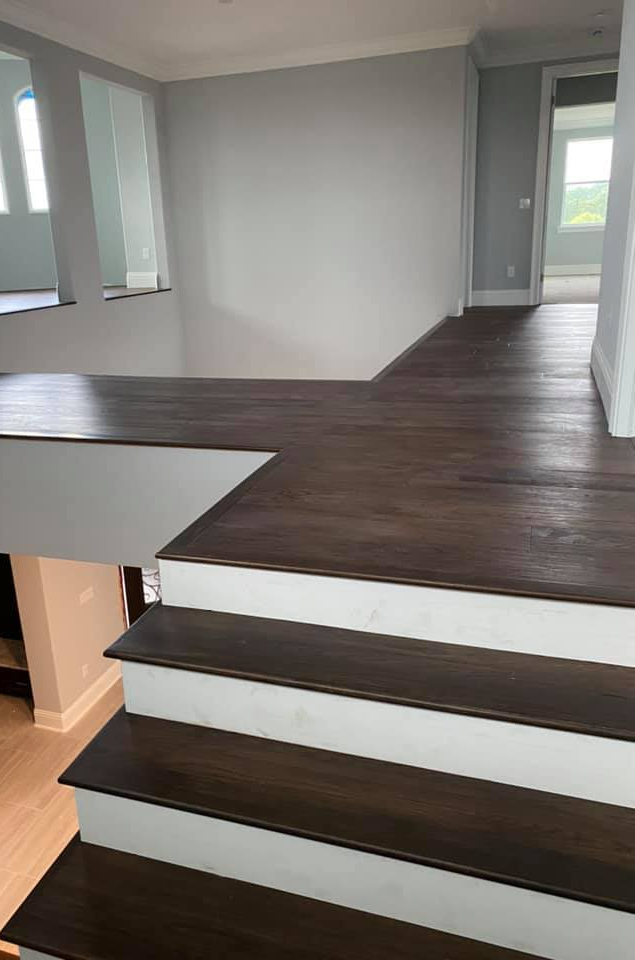 The contrast between dark wood finish and white baseboards makes this upstairs space look beautiful.
