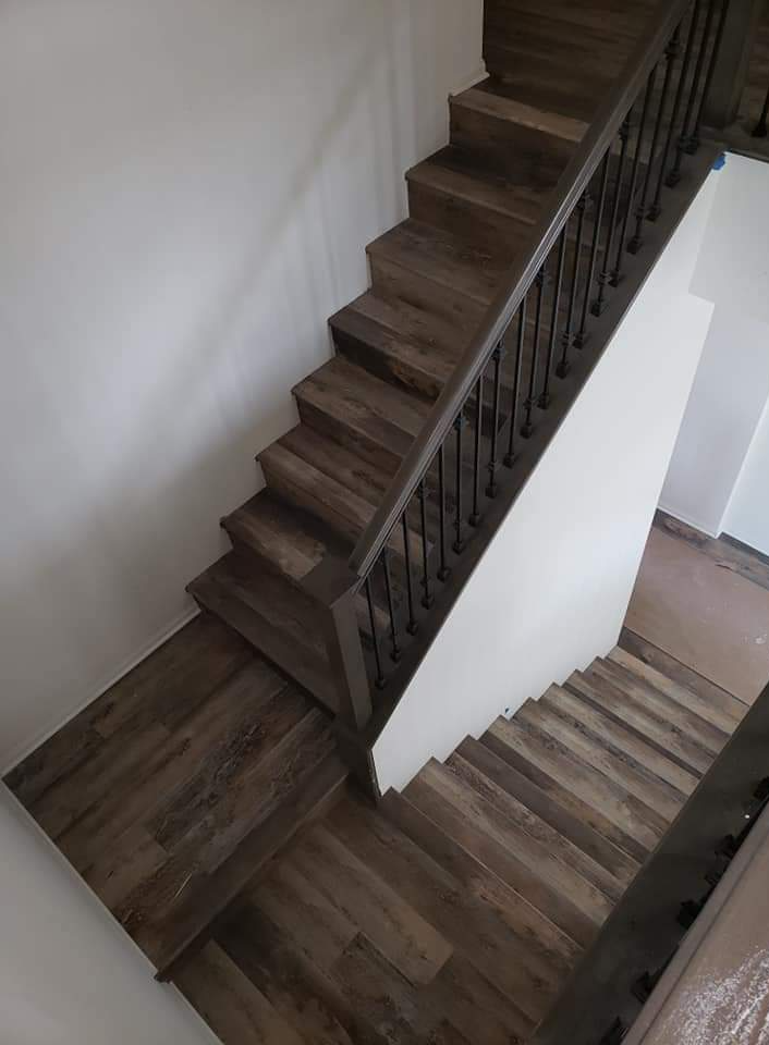 A darker shade of engineered wood flooring has been installed on this staircase.