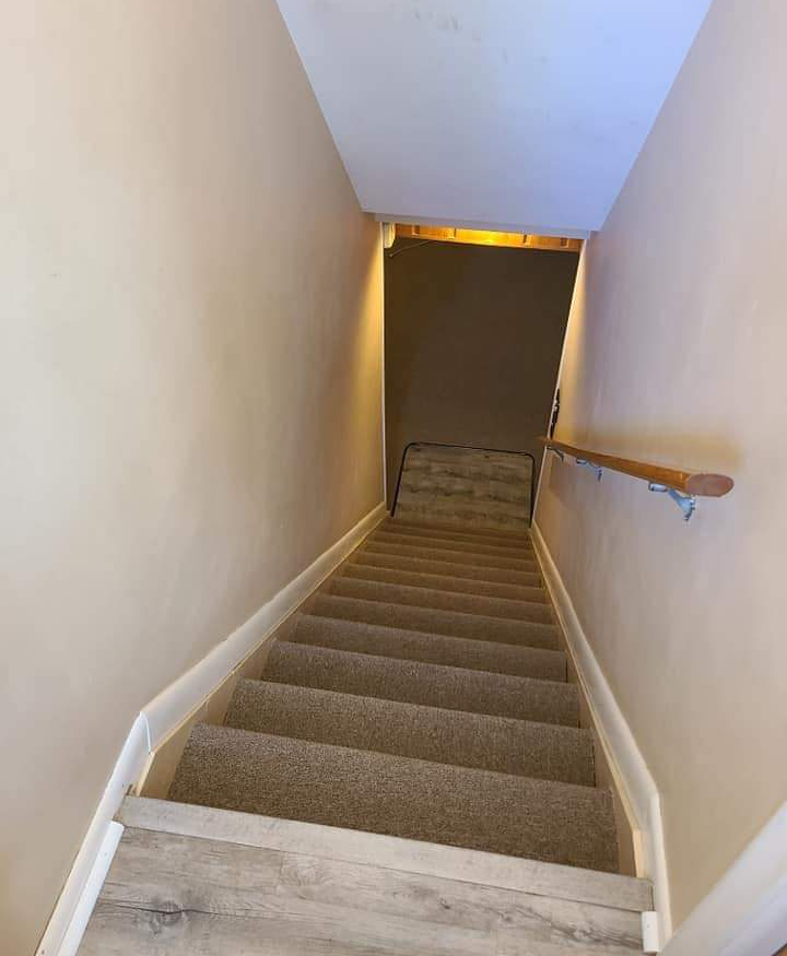 Carpet has been expertly installed on this staricase as the finishing touch to this basement renovation.