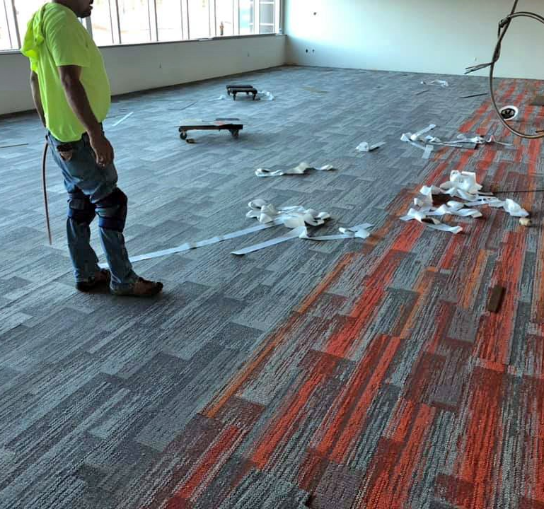 A hotel conference room gets some new commercial carpet tiles installed.