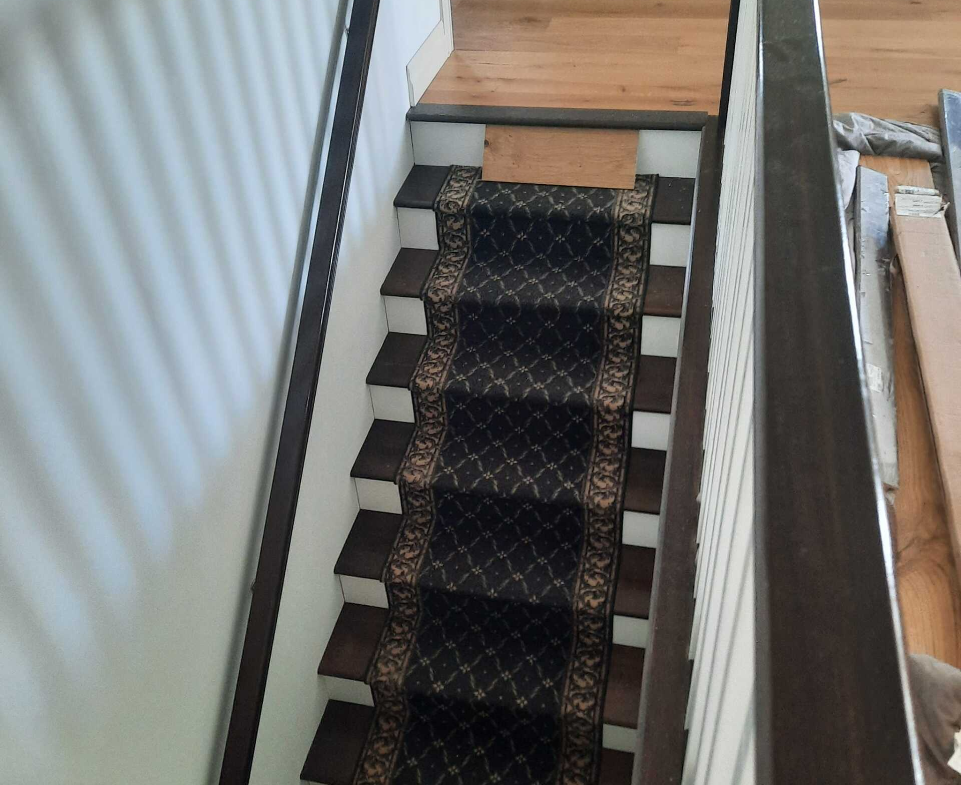 Our flooring contractors complete a wood floor installation atop this set of stairs.
