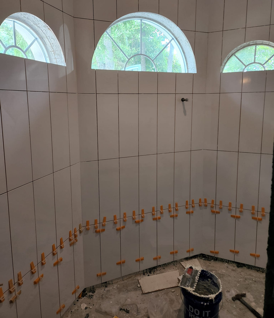 Shower tile installation in a beautiful bathroom.